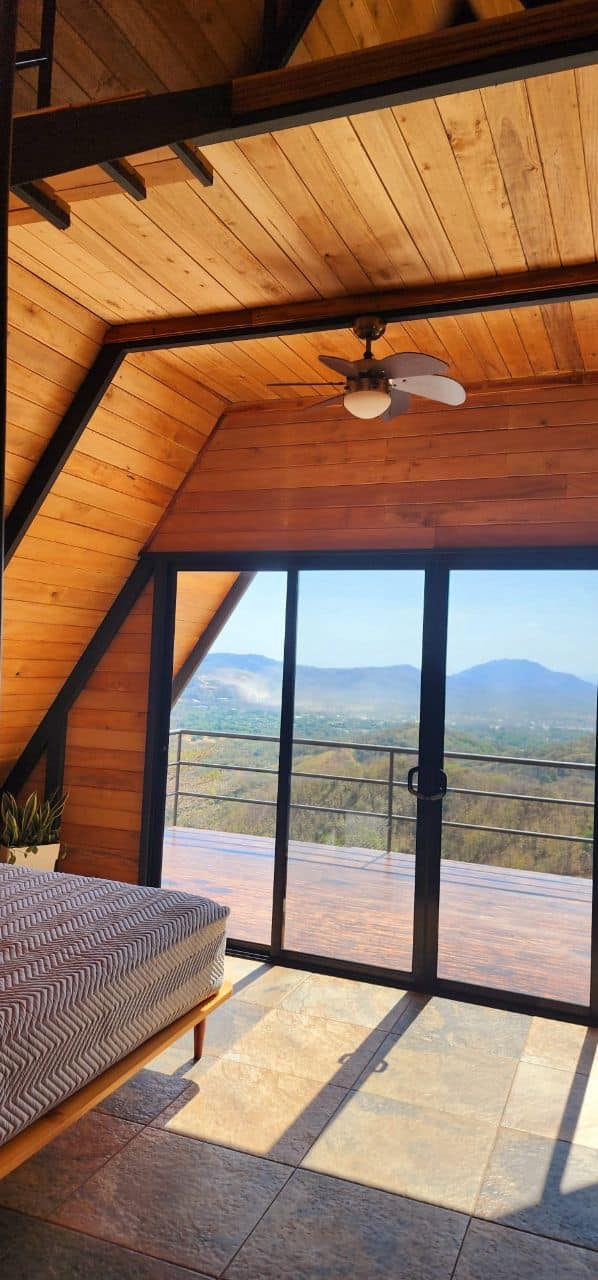 Interior A-frame cabin wooden ceiling fan mountain view luxury comfort vacation rental Costa Rica retreat