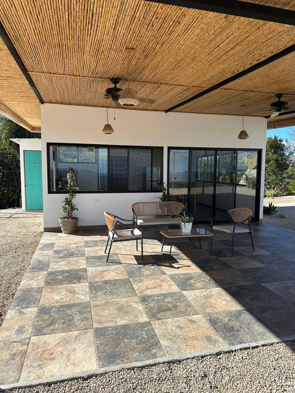 Covered terrace modern furniture bamboo roof large windows luxury vacation rental Costa Rica upscale stay