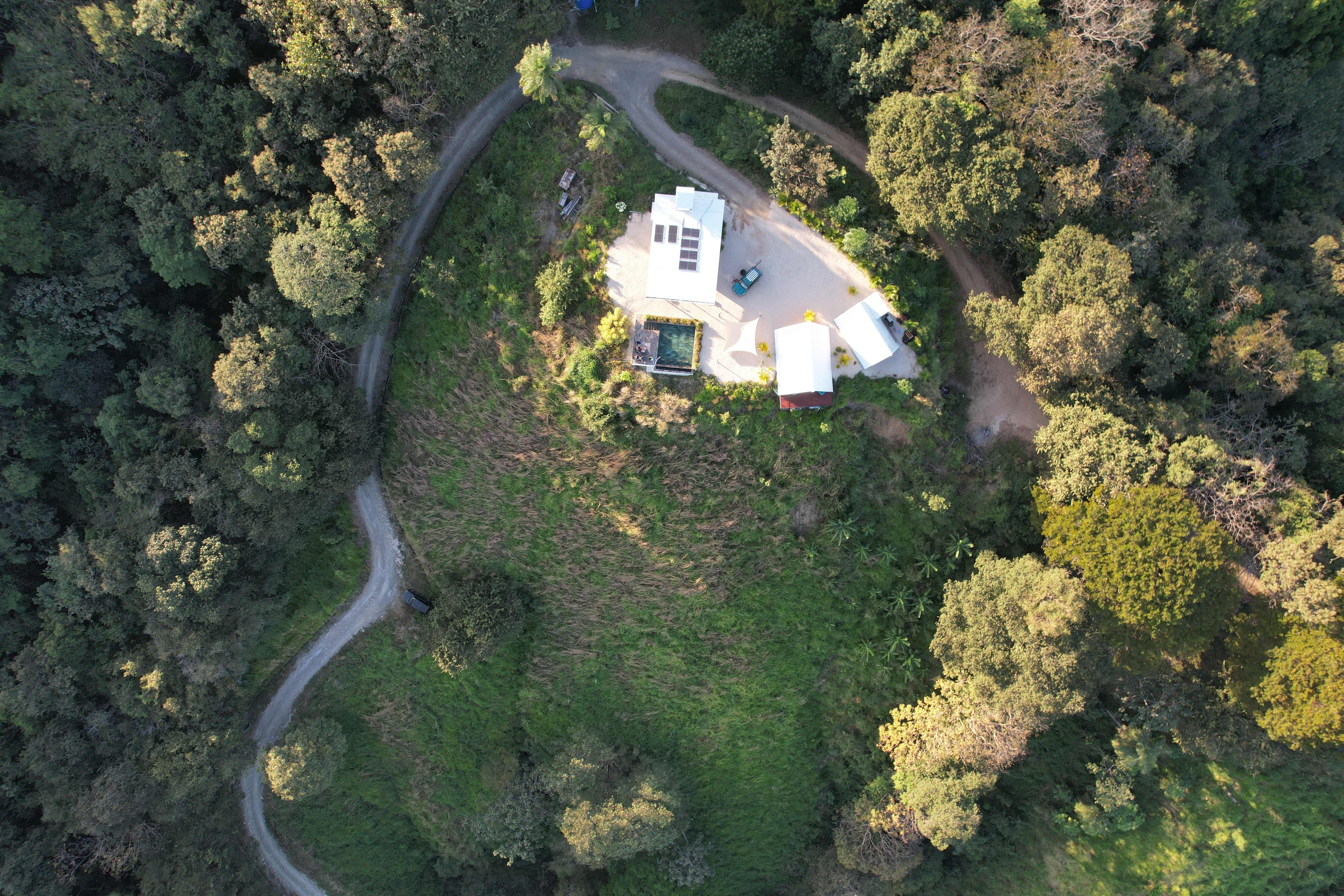 Top aerial view exclusive luxury vacation rental Bluesky Lodge design winding roads Blue Zone Costa Rica
