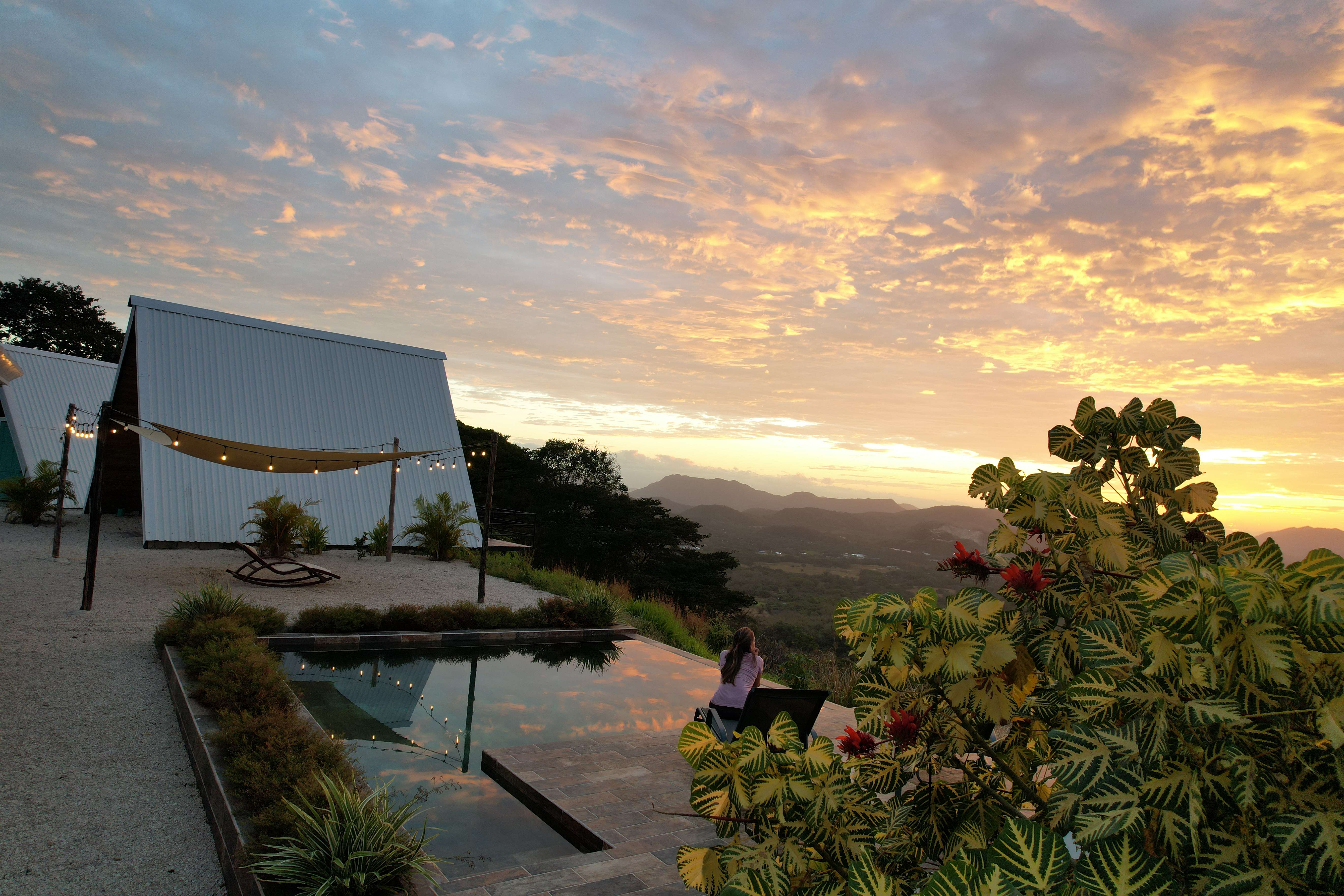 Infinity pool sunrise tropical plants mountain view luxury vacation rental Costa Rica exclusive stay