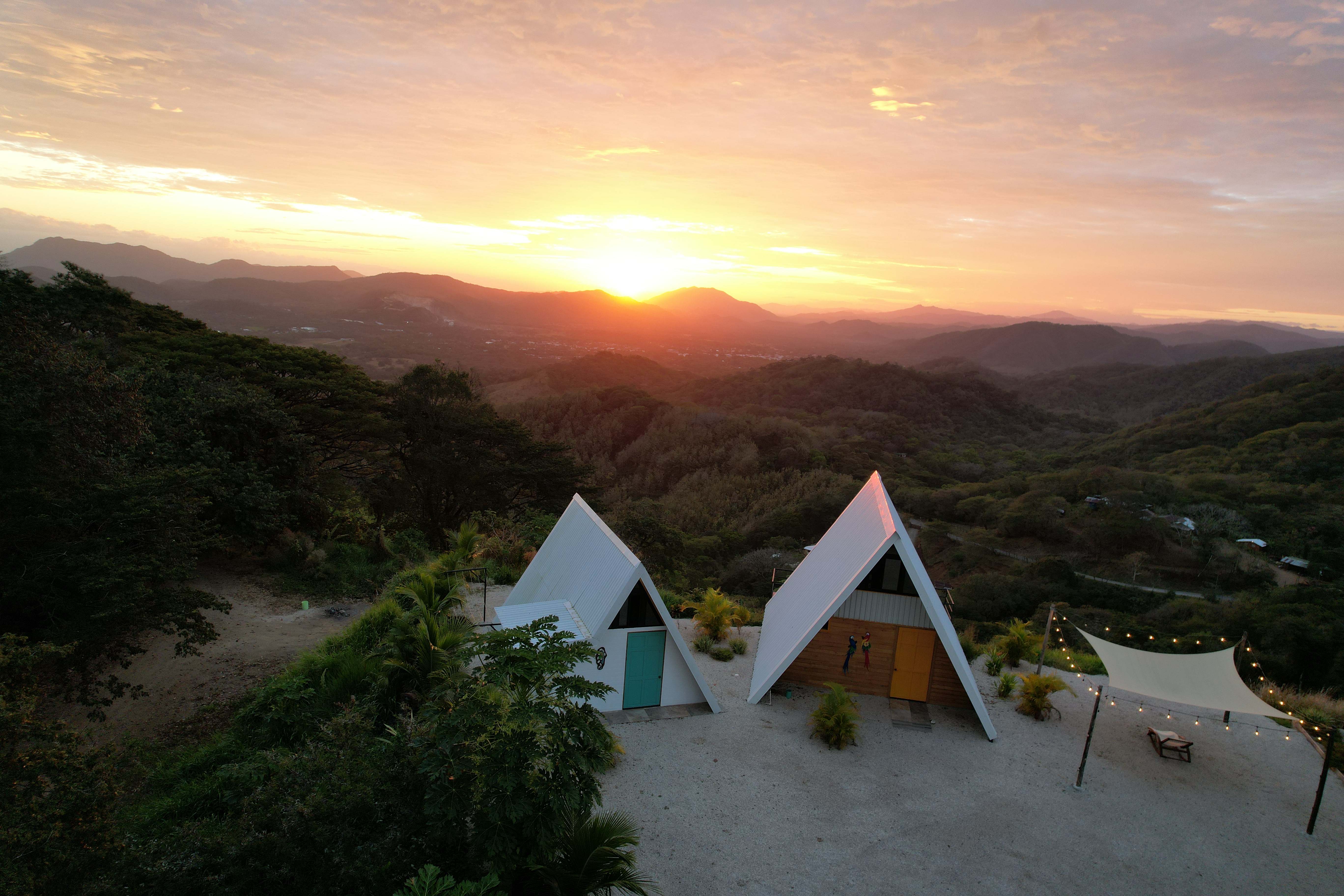 Sunrise A-frame structures golden sky luxury vacation rental Bluesky Lodge Costa Rica mountain retreat